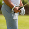 Male golfer tagging CONNEX tag against his mobile phone in his pocket