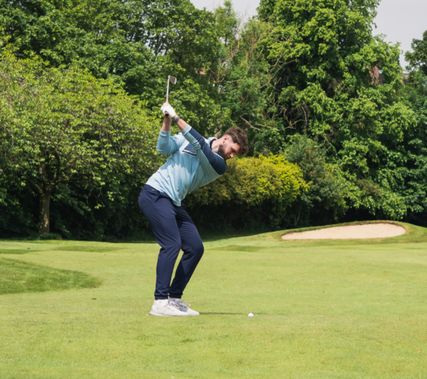 Male golfer hitting a shot wearing black G4 GPS watch