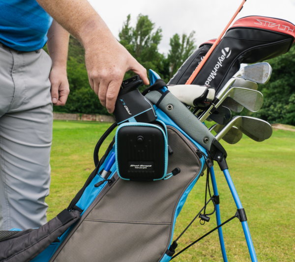 Male golfer taking blue PRO LX+ rangefinder out of carry case