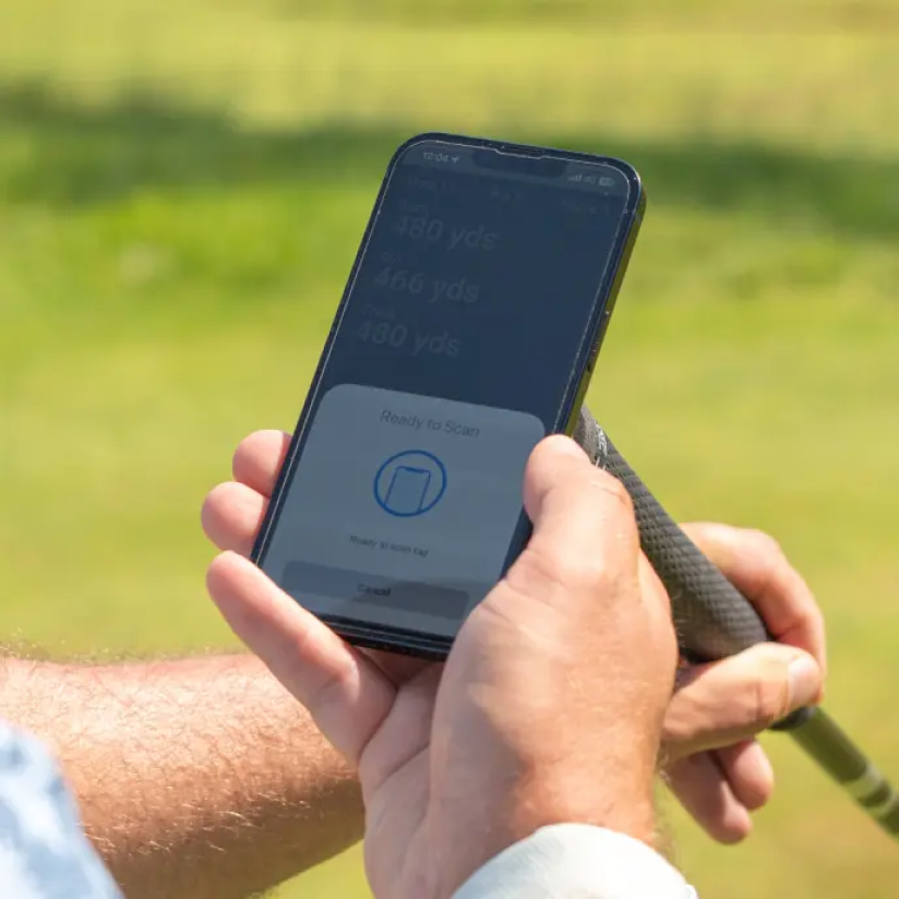 golfer tagging phone with connex tag in club