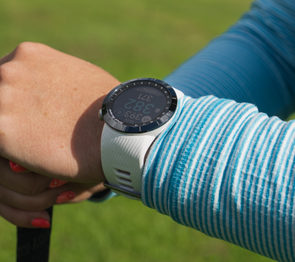 Female golfer wearing white X5 GPS watch