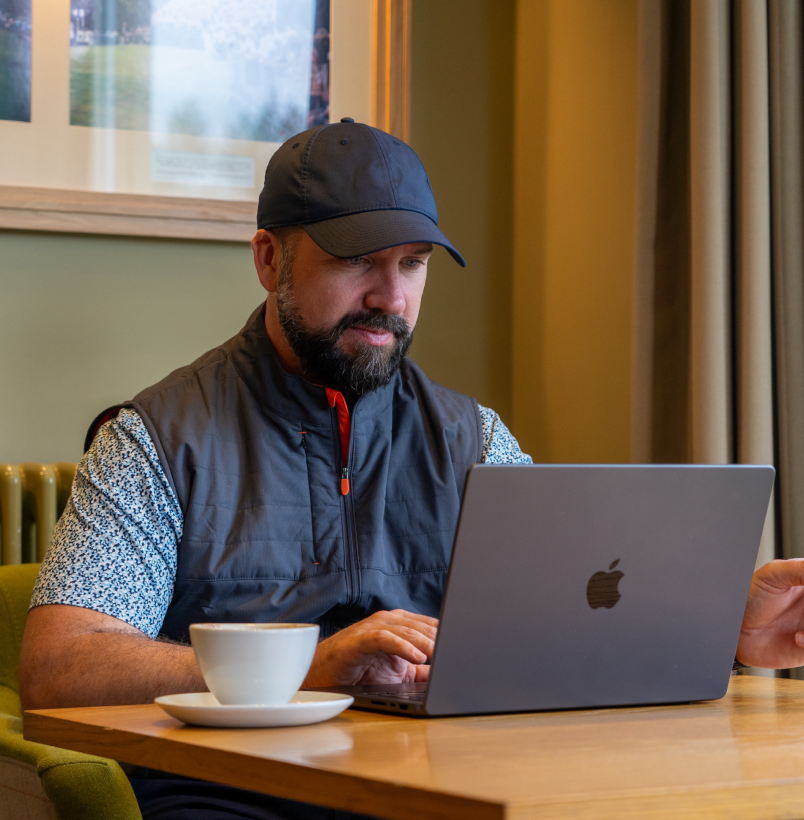 shot scope ambassador peter finch reading a shot scope ebook on laptop