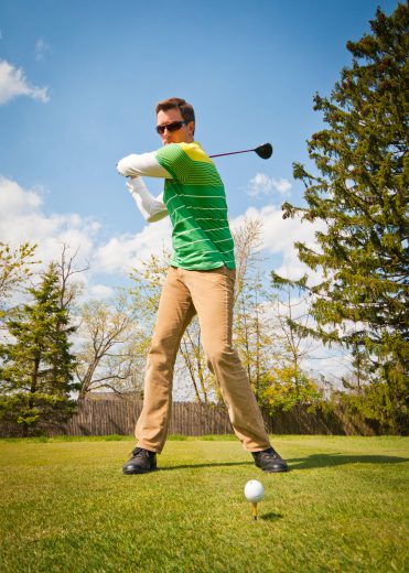 Man at the top of the backswing with driver