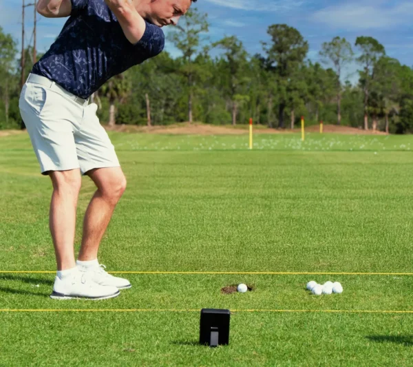 Shot Scope LM1 Launch Monitor on golf course with golfer
