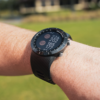 Male golfers wearing Prestige black X5 GPS watch with hazards view