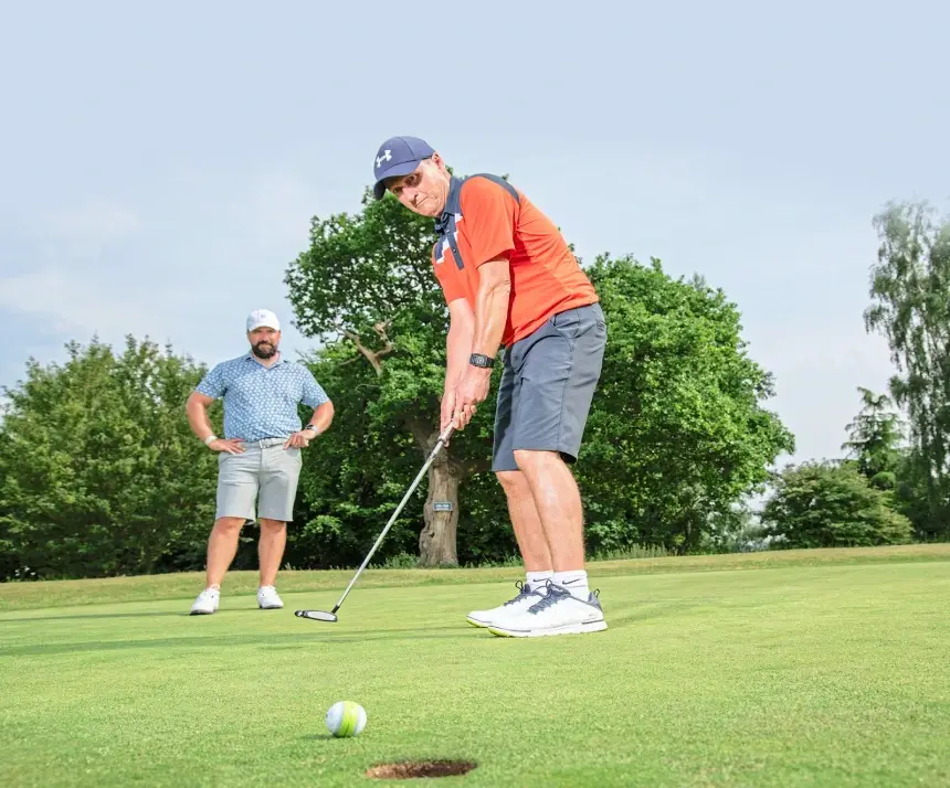 peter finch golf coach overlooking an 18 handicap golfer hit a putt