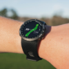 Female golfer wearing Black V5 GPS watch with hole maps screen