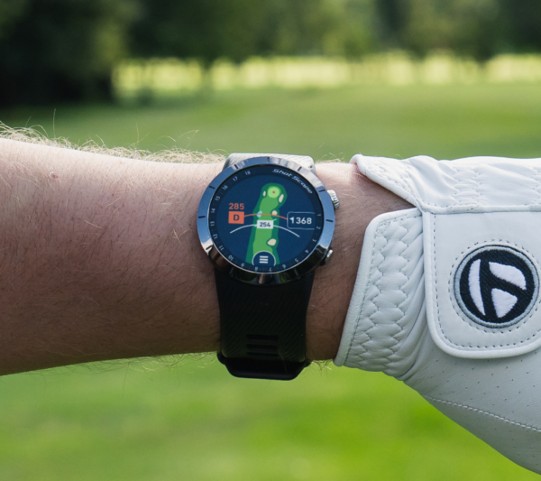 Male golfer wearing Prestige black X5 GPS watch with Full hole maps