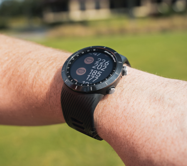 Male golfers wearing Prestige black X5 GPS watch with hazards view