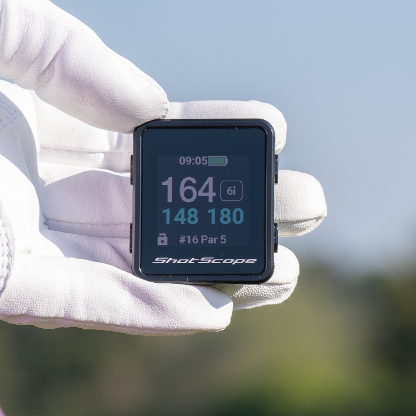 golfer holding h4 gps handheld in hand