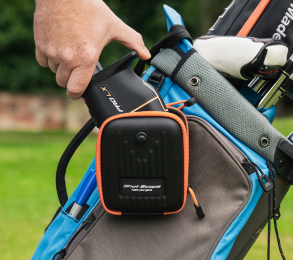 Male golfer taking Orange PRO LX rangefinder out of Shot Scope carry case