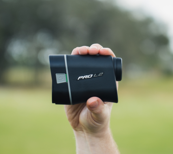 Male golfer holding Grey PRO L2 rangefinder showing left side