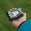 Male golfer holding PRO ZR rangefinder showing slope switch