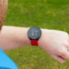 Golfer looking at red Shot Scope G6 on wrist with hazards on screen