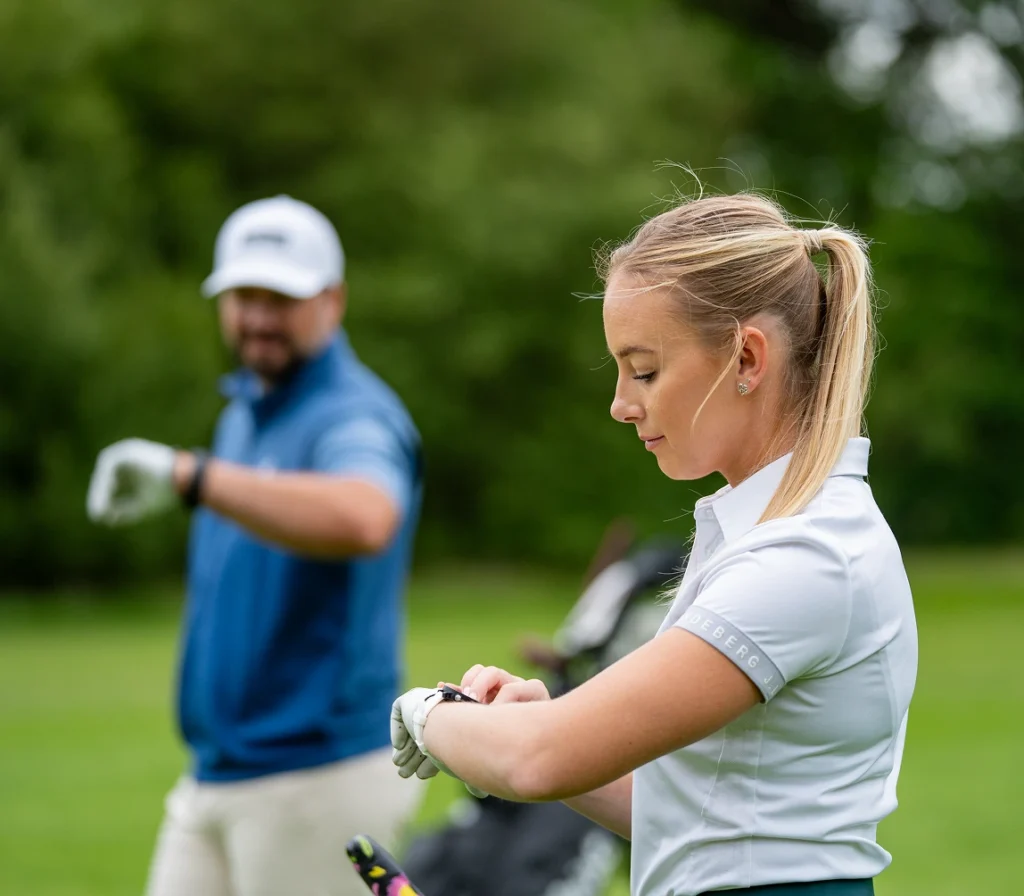 Lauren Golf and Peter Finch on the golf course using GPS watches